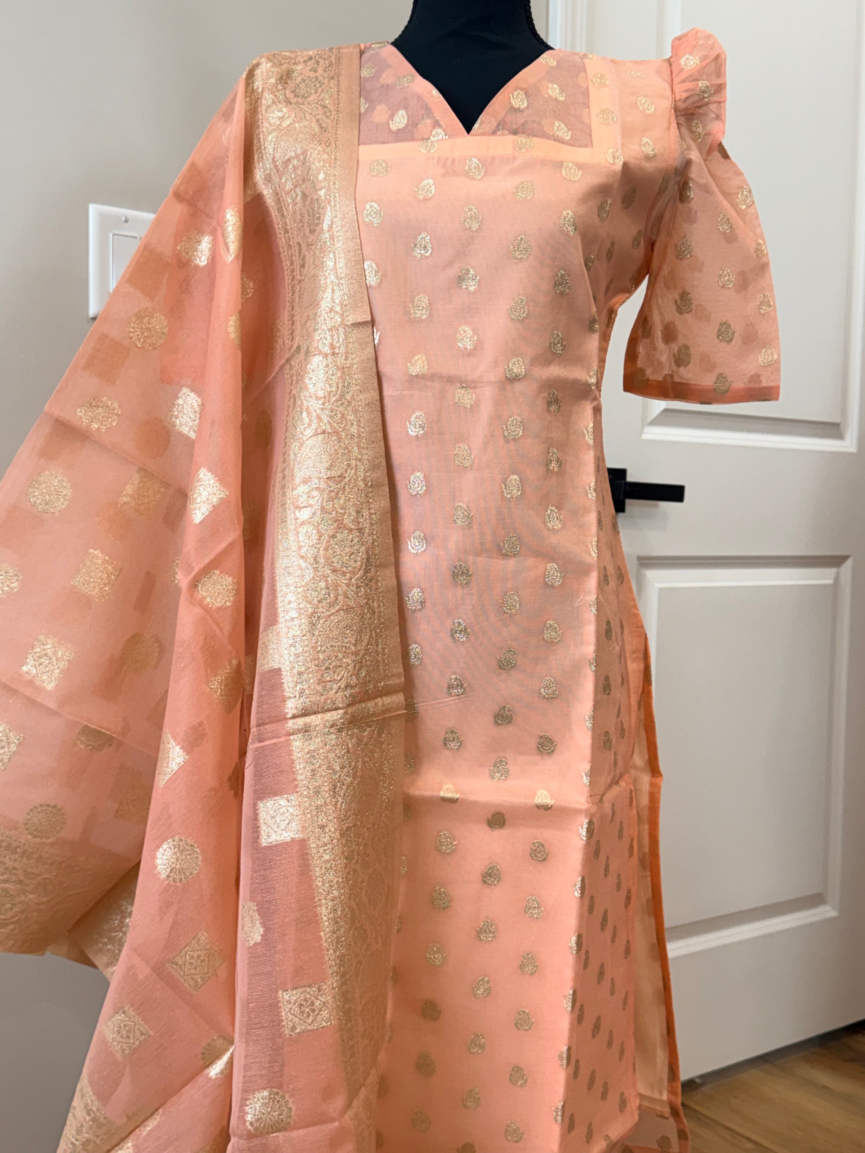 Kanakambaram color kurti set paired with gold leggings