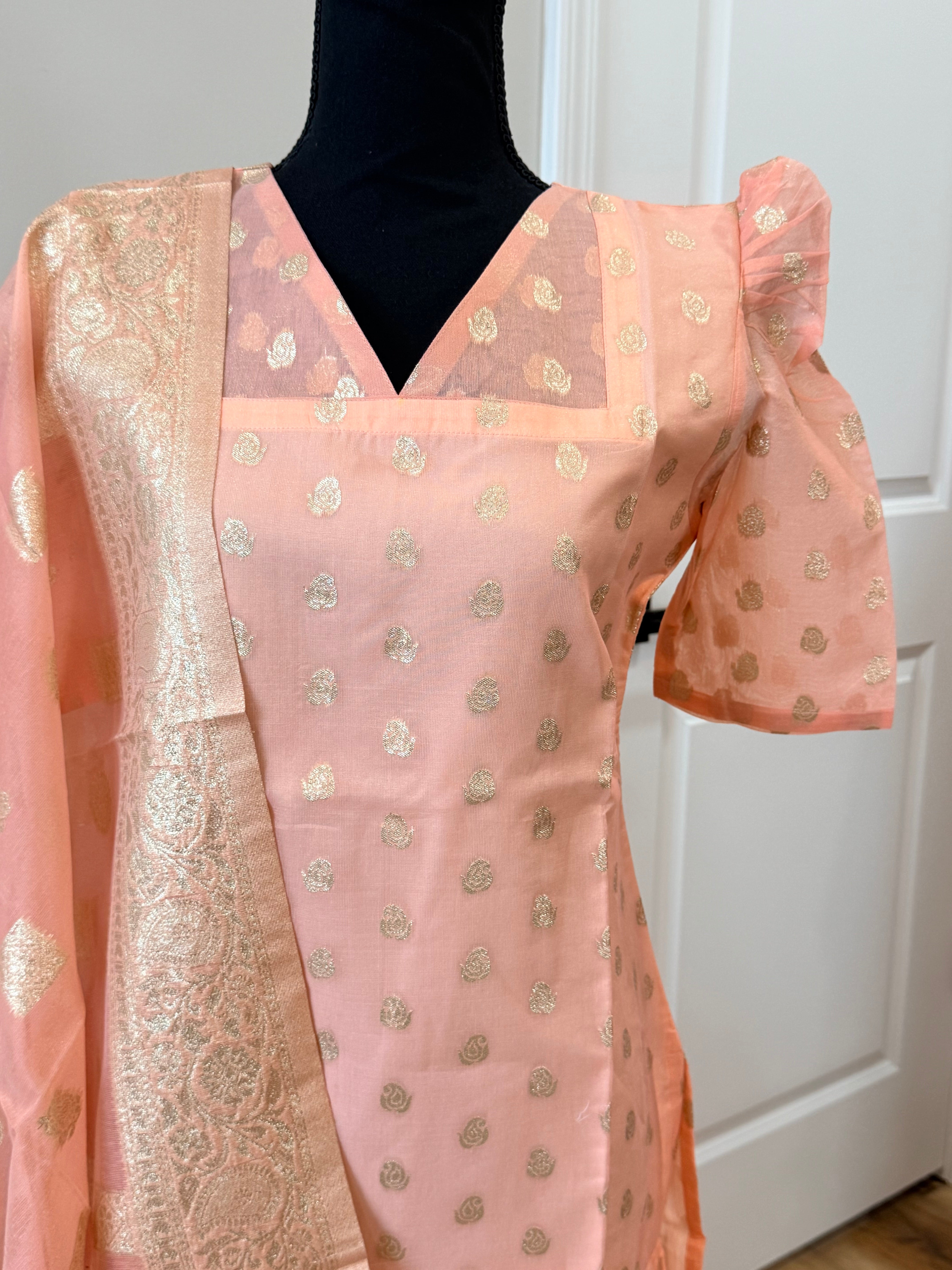 Kanakambaram color kurti set paired with gold leggings